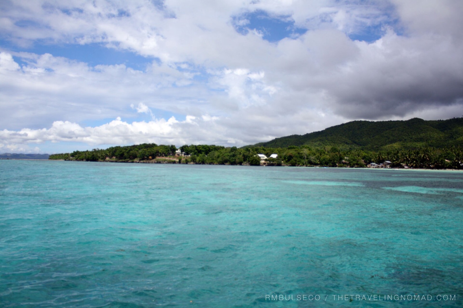 Turquoise shallows along the green coast of Siquijor